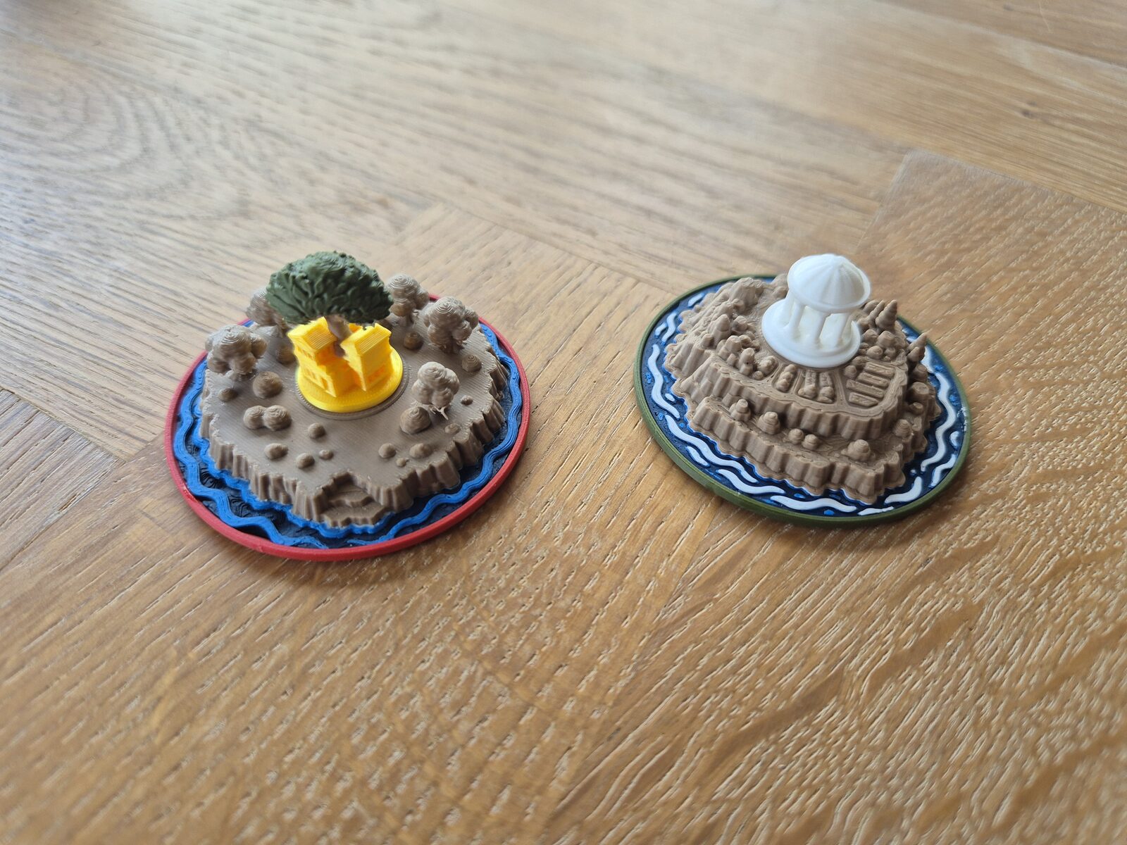 Two sculpted island miniatures printed in wood-like PLA.